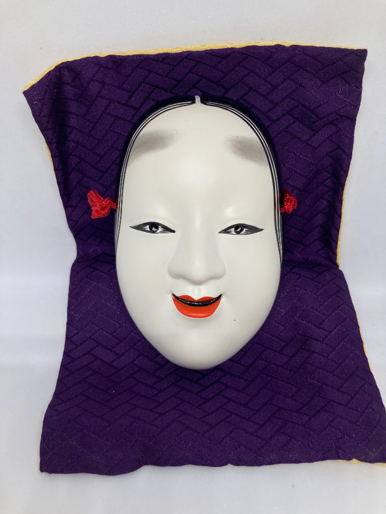 Japanese mask on purple cloth
